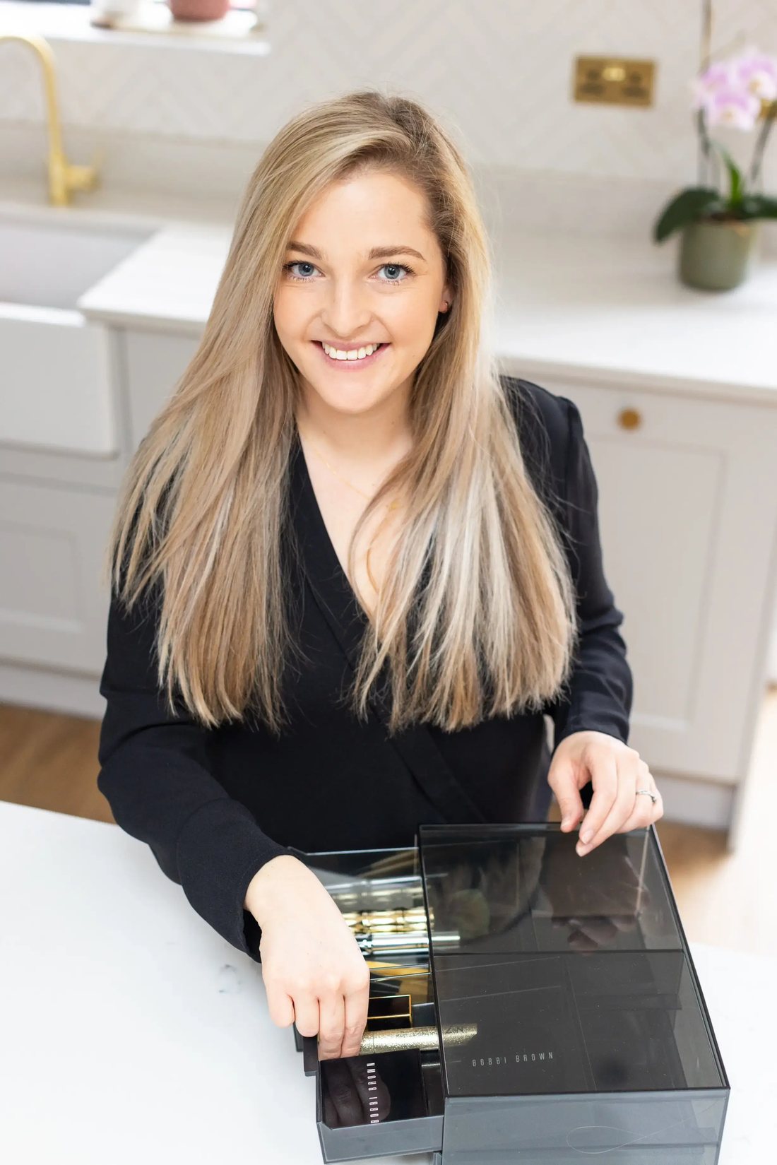 Lucy Mansey at her desk with neatly organised trays